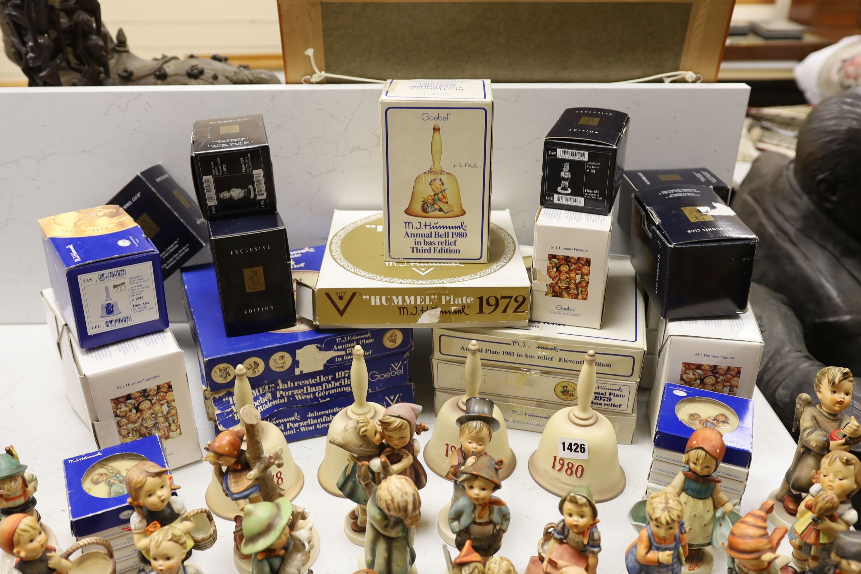 A large collection of Hummel pottery figures, approximately 70 including skier and two similar plaques, some with boxes.